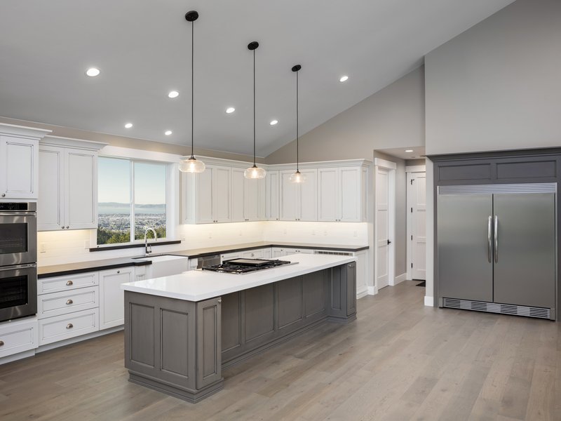 young family entering empty house with new floors